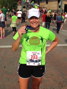 Melissa Gindling from PI shows off her medal for a 14K race through downtown Cincinnati, Ohio, U.S.